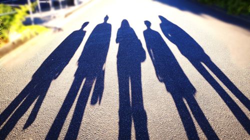 Shadow of people on road