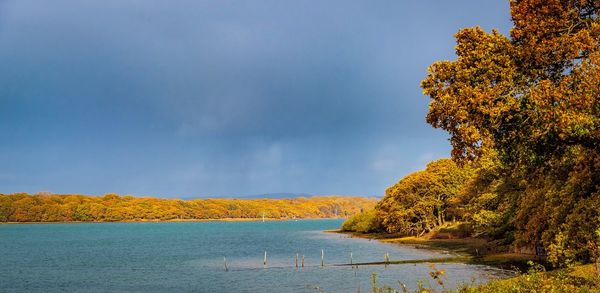 Scenic view of lake against sky during autumn