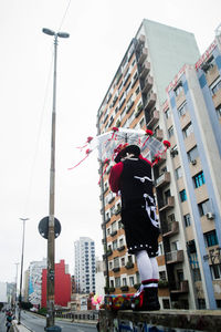 People in city against sky