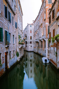 Canal amidst buildings in city