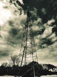 Low angle view of electricity pylon against sky