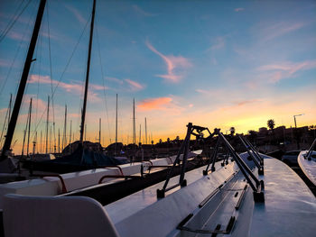 Sailboats in marina at sunset