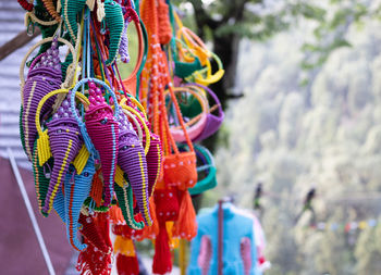 Selective focus on number of hand crafted colorful items hanging in an indian market shop
