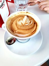 Close-up of cappuccino served on table