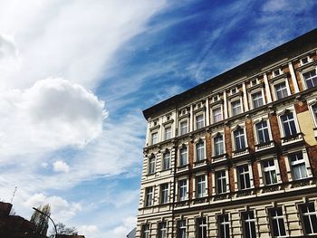 Low angle view of building against cloudy sky