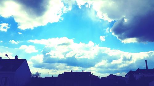 Low angle view of building against cloudy sky