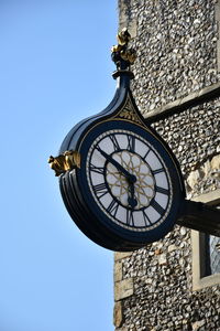 Low angle view of clock tower against clear sky