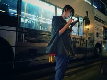 Rear view of woman standing in tunnel