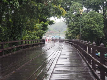 View of wet footbridge on footpath during rainy season
