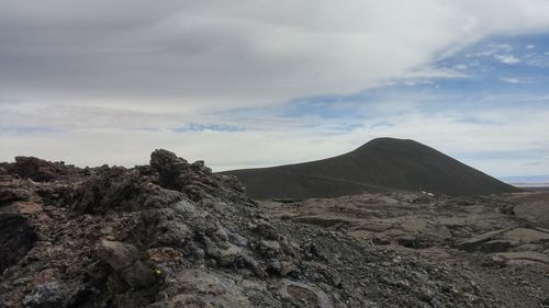 Scenic view of mountains against cloudy sky