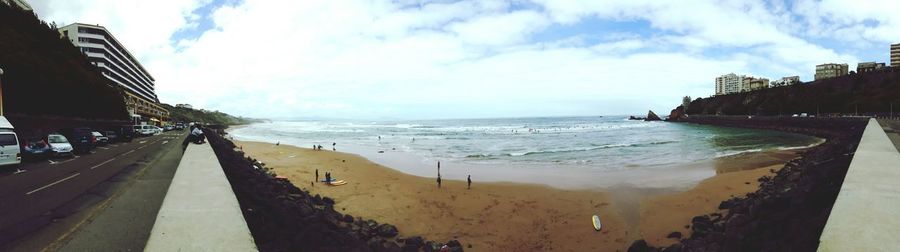 Panoramic view of beach against cloudy sky