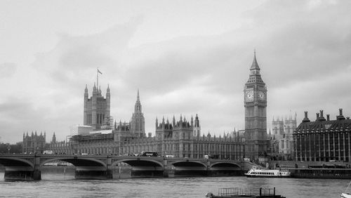 Westminster bridge over thames river against sky