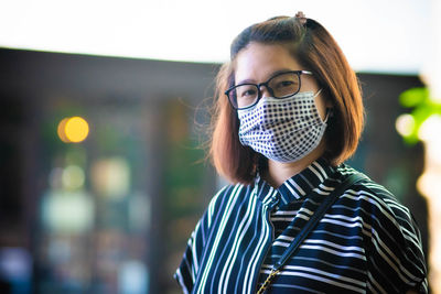 Portrait of young woman standing outdoors