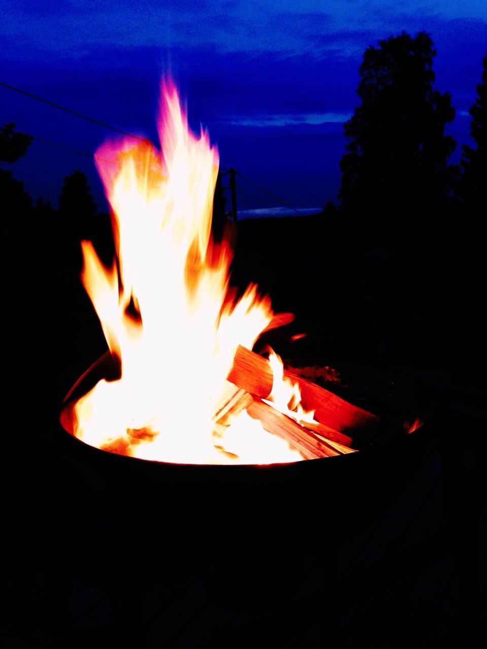 burning, flame, fire - natural phenomenon, heat - temperature, glowing, fire, night, bonfire, campfire, orange color, dark, heat, close-up, motion, one person, light - natural phenomenon, firewood, long exposure, illuminated, sky