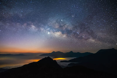 Scenic view of mountains against sky at night