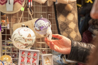 Midsection of person holding mask at store