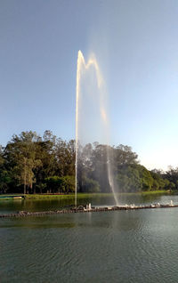 View of fountain in lake against sky