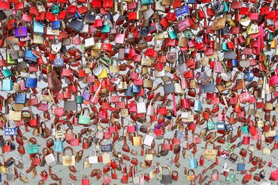 Full frame shot of padlocks hanging on brick wall