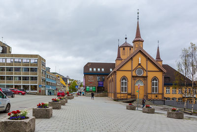 Panoramic view of buildings and street against sky