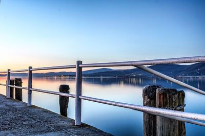 Bridge over water against clear blue sky