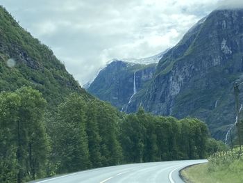 Road amidst mountains against sky