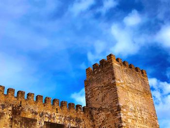 Low angle view of fort against blue sky