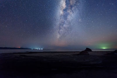 Majestic view of sea against star field at night