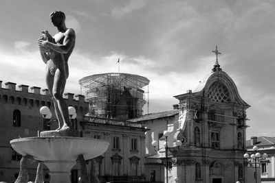 Low angle view of statue against cloudy sky