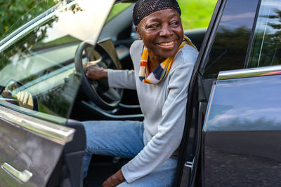 Portrait of young man sitting in car