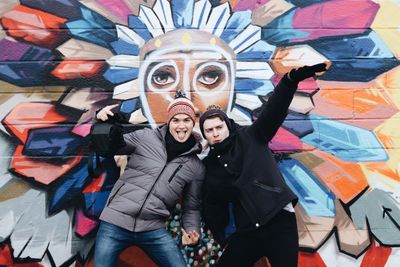 Portrait of young couple standing outdoors