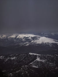 Aerial view of snowcapped mountains against sky