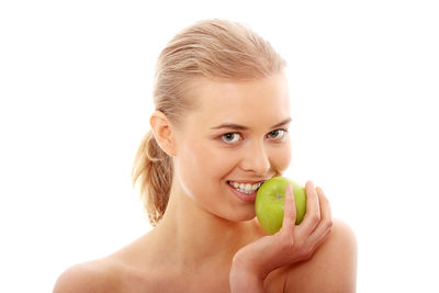 Portrait of a smiling young woman against white background
