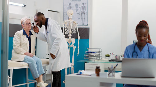 Female doctor examining patient in laboratory