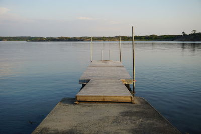 Pier over lake against sky