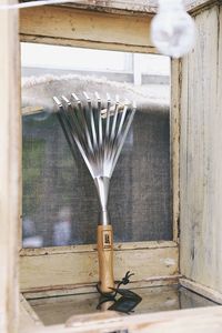 Close-up of electric lamp on table by wall