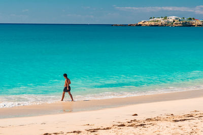 Full length of man on beach against sky