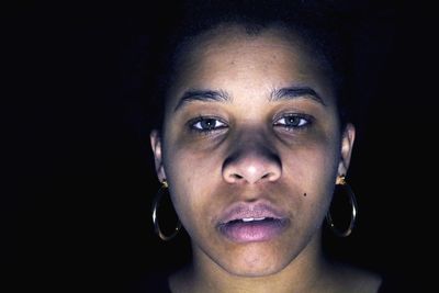 Portrait of man against black background