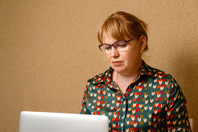 Portrait of elegant mature woman wearing eyeglasses and looking at camera. closeup face of confident