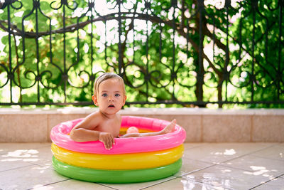 Girl sitting in bathtub