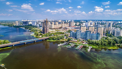 High angle view of river amidst buildings against sky