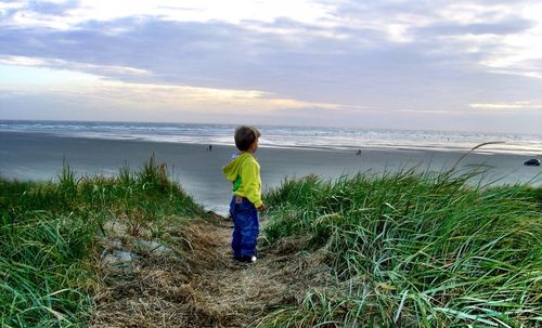 Rear view of man standing on beach