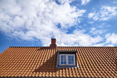 Low angle view of building against cloudy sky