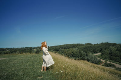 Full length of woman on field against sky