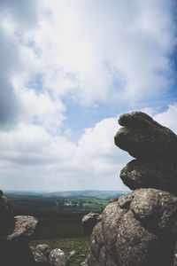 Stack of rocks on shore against sky