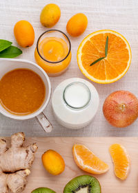 Directly above shot of fruits and juicer on table