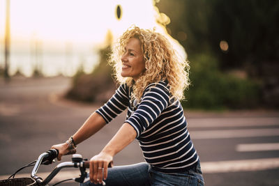 Smiling woman riding bicycle