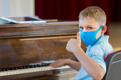 Portrait of boy playing piano