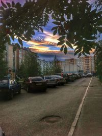 Cars on road with buildings in background