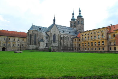 Facade of church against cloudy sky