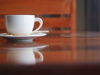 Close-up of coffee cup on table